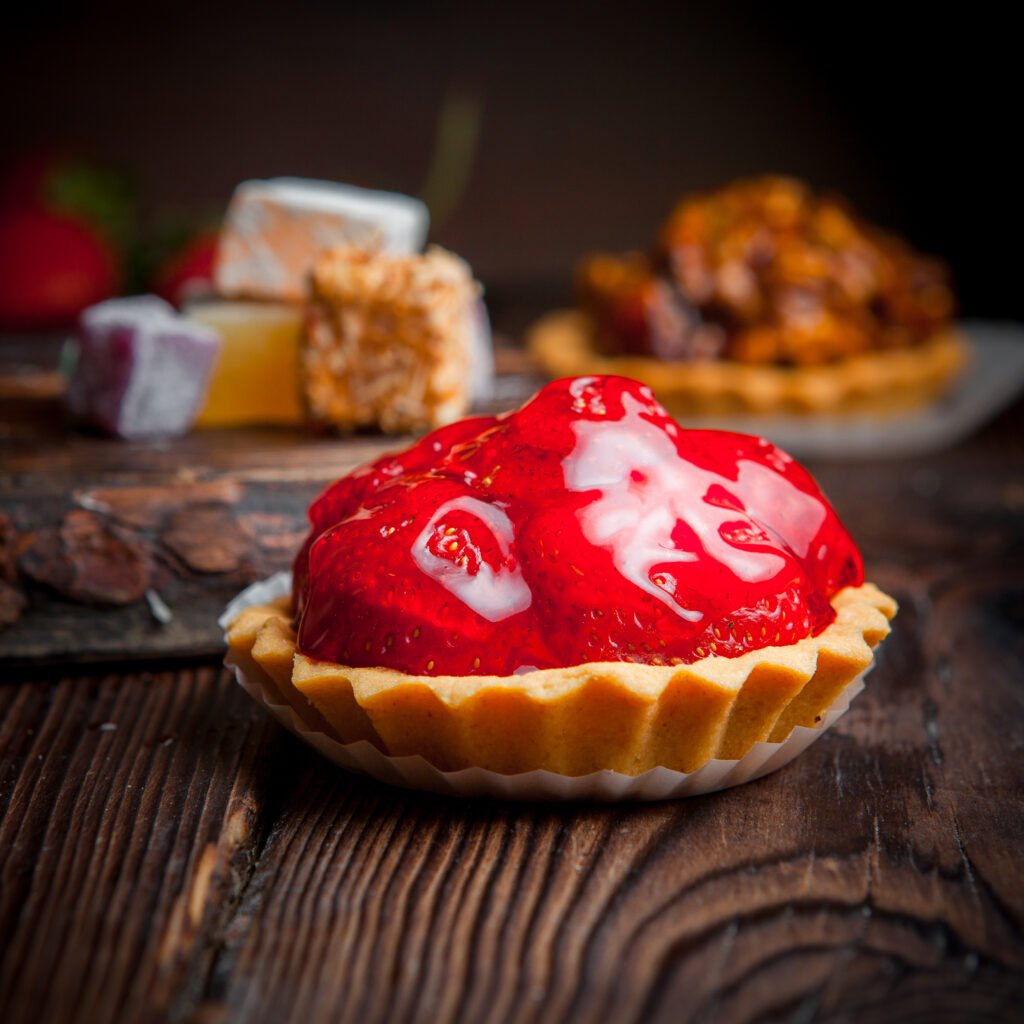 side vew strawberry pie tarts with nuts pie tarts on wood background
